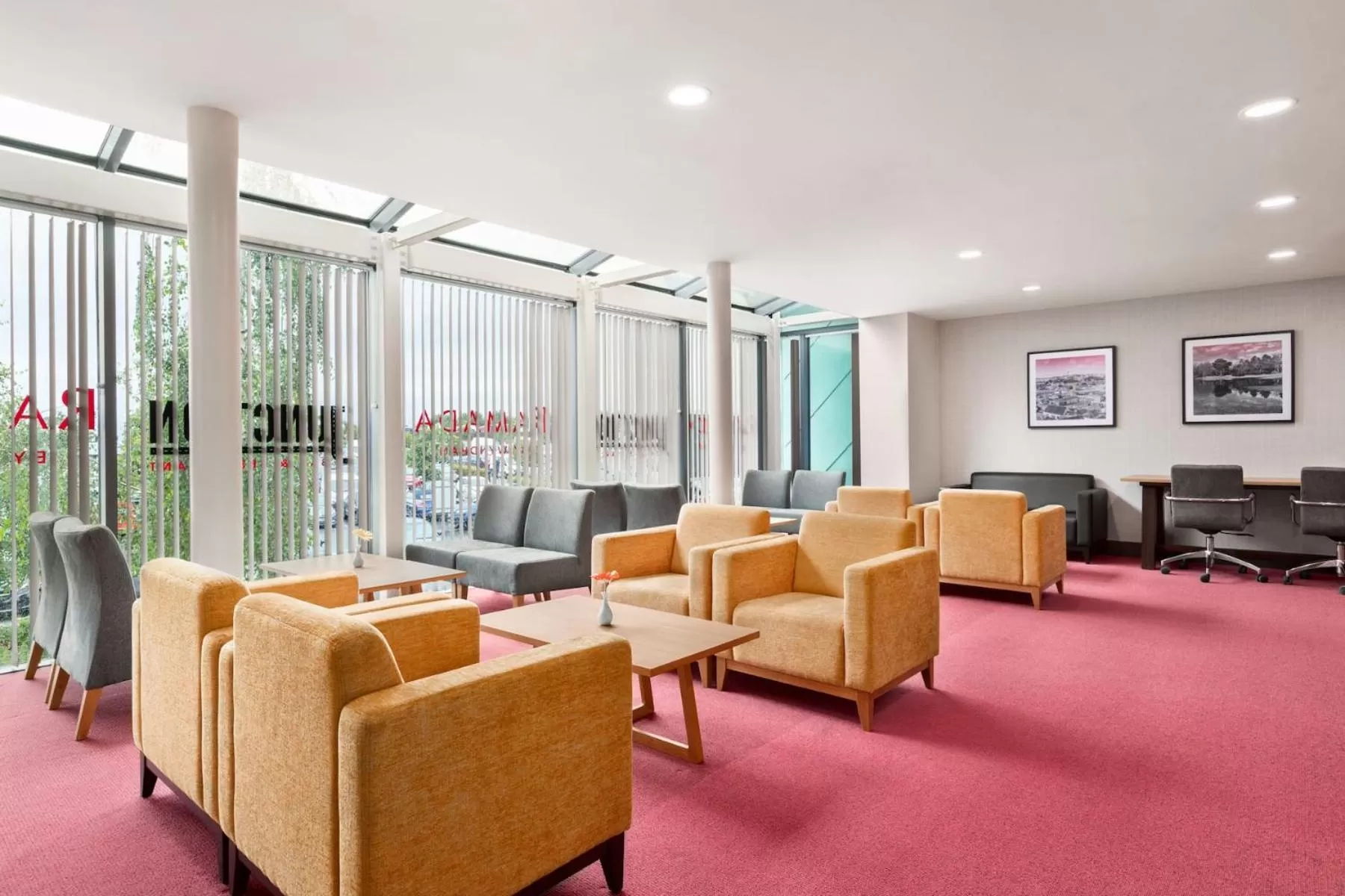 Communal lounge/ TV room in Ramada by Wyndham Cobham