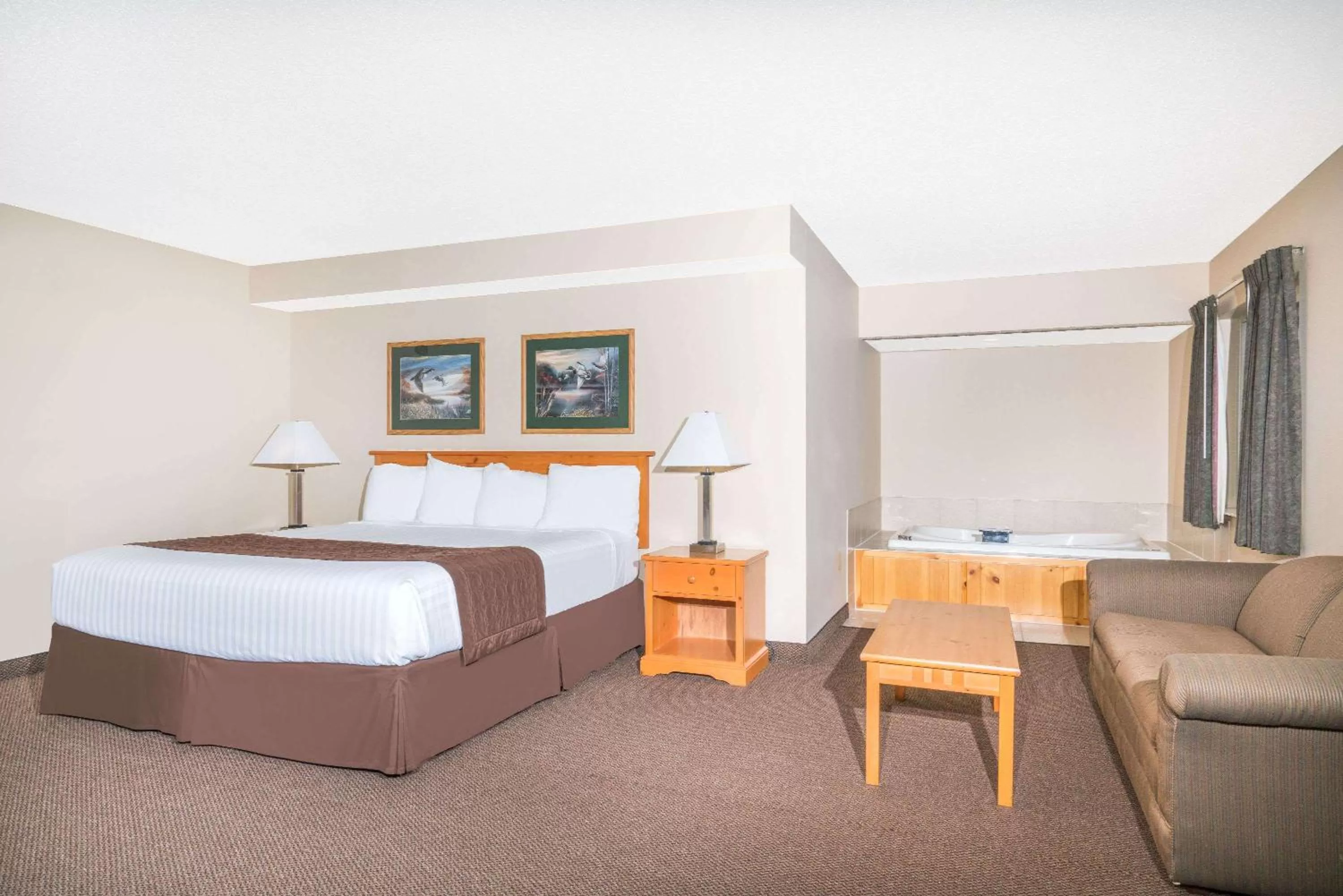 Photo of the whole room, Bed in Baymont by Wyndham Baxter/Brainerd Area