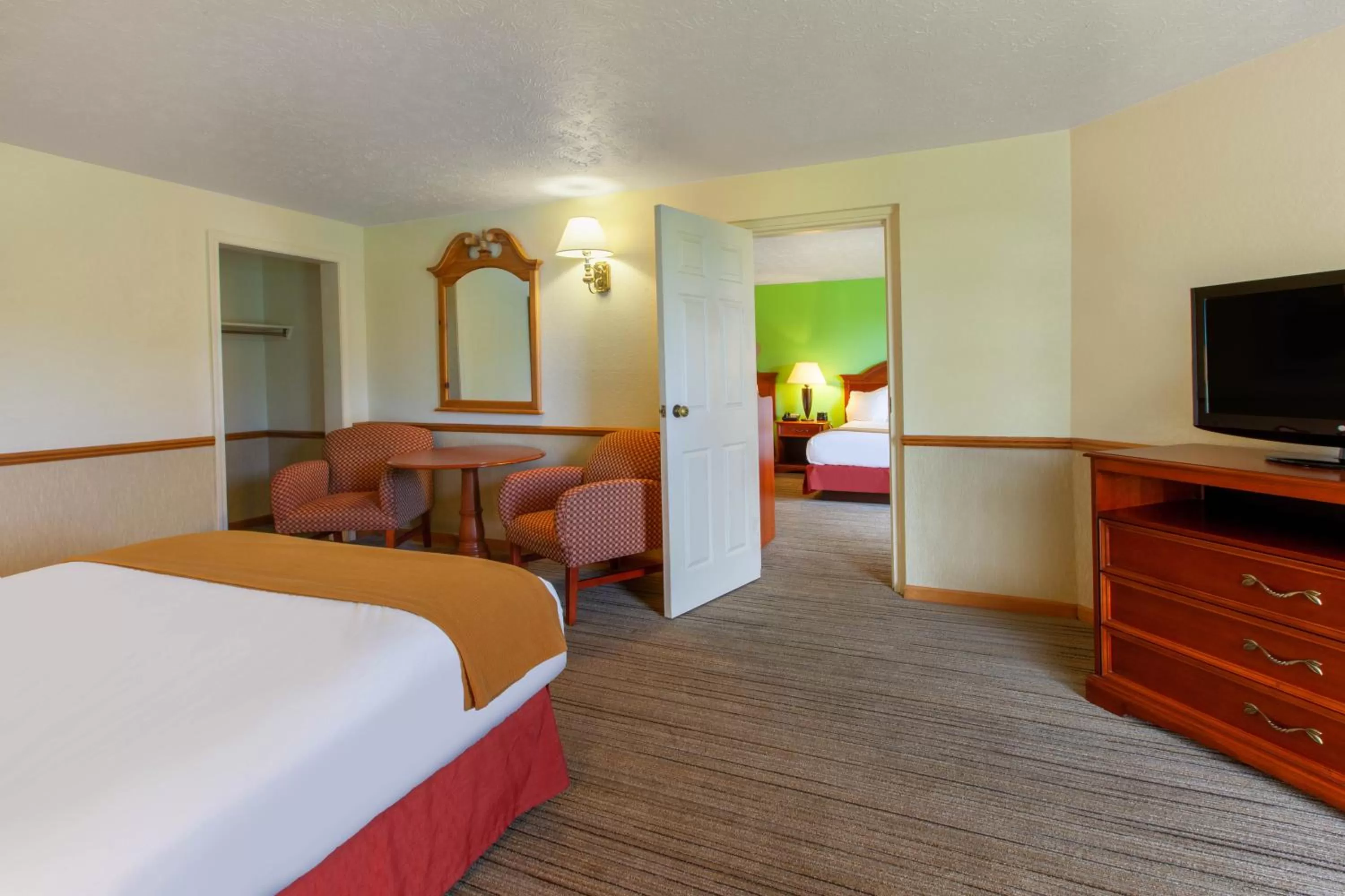 One-Bedroom Suite with Three Queen Beds and Patio in Apple Tree Inn; SureStay Collection by Best Western
