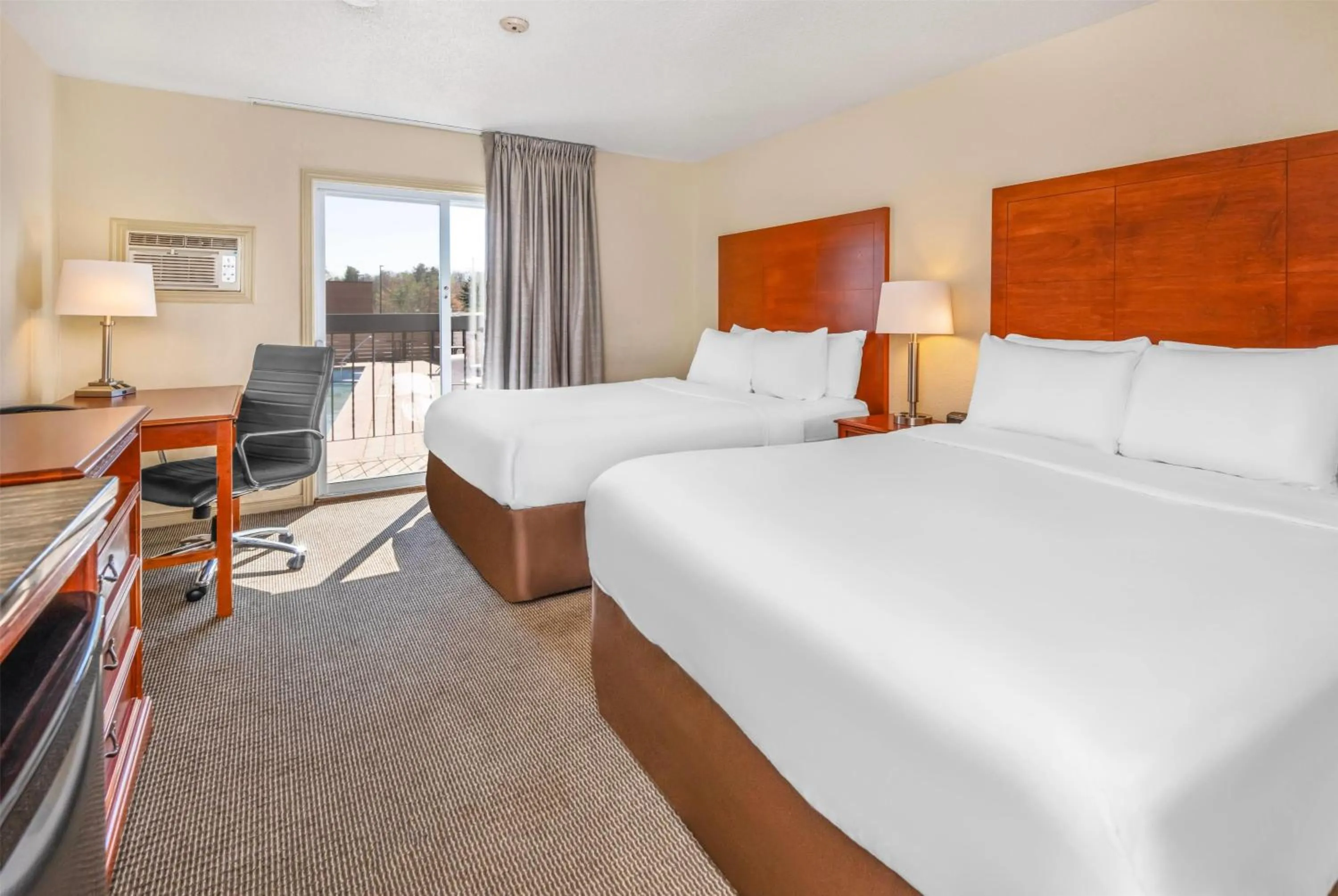 Queen Room with Two Queen Beds and Pool View -  Non-Smoking in Travelodge by Wyndham Gananoque