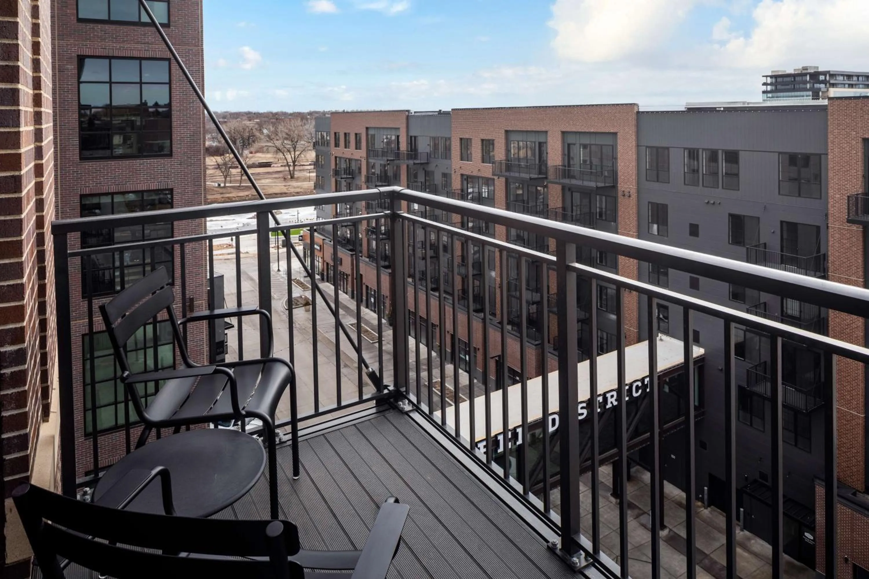Corner King Room with Balcony and Steel District View in Canopy By Hilton Sioux Falls Downtown