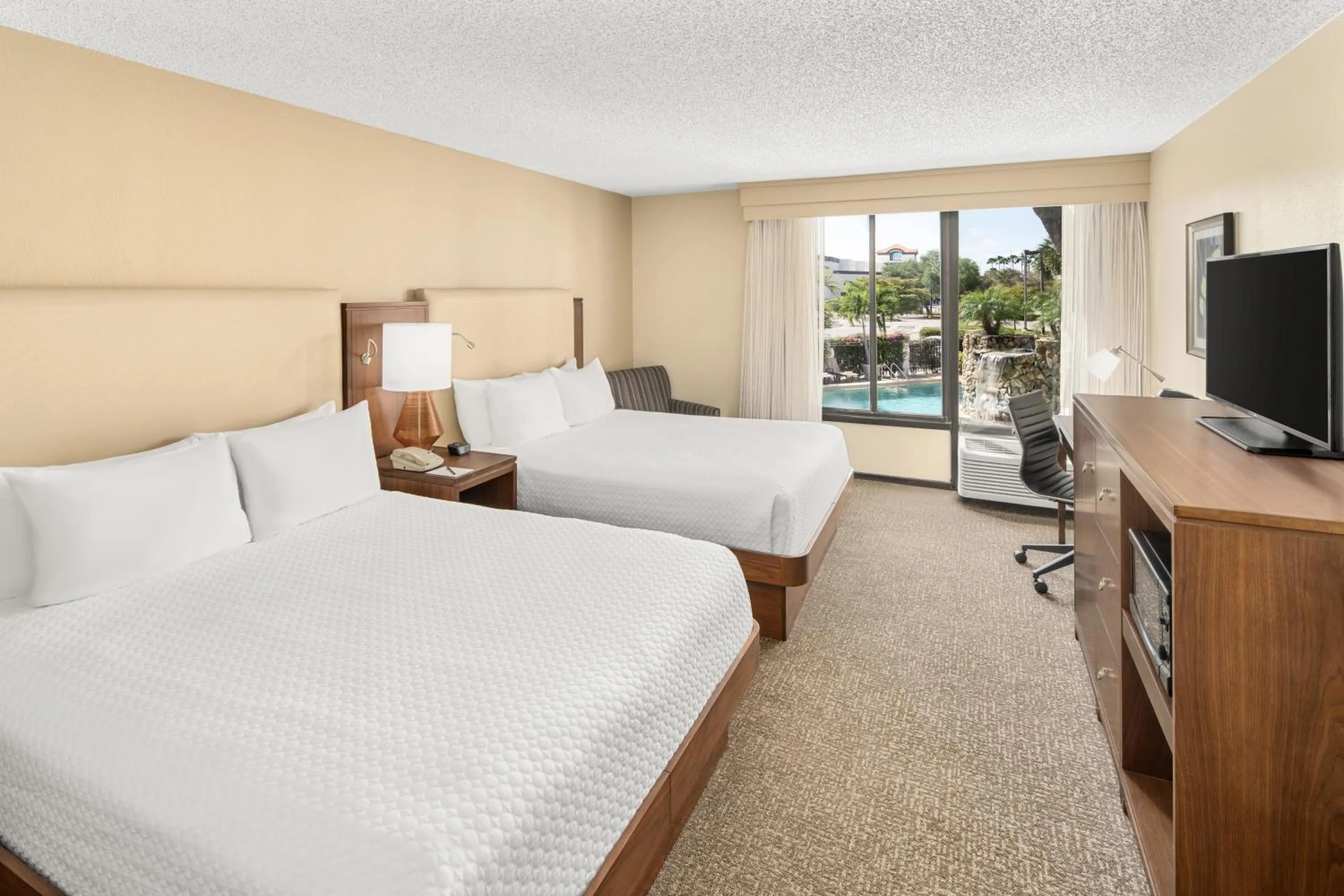 Queen Room with Two Queen Beds and Pool View in Crowne Plaza Hotel Fort Myers at Bell Tower Shops, an IHG Hotel