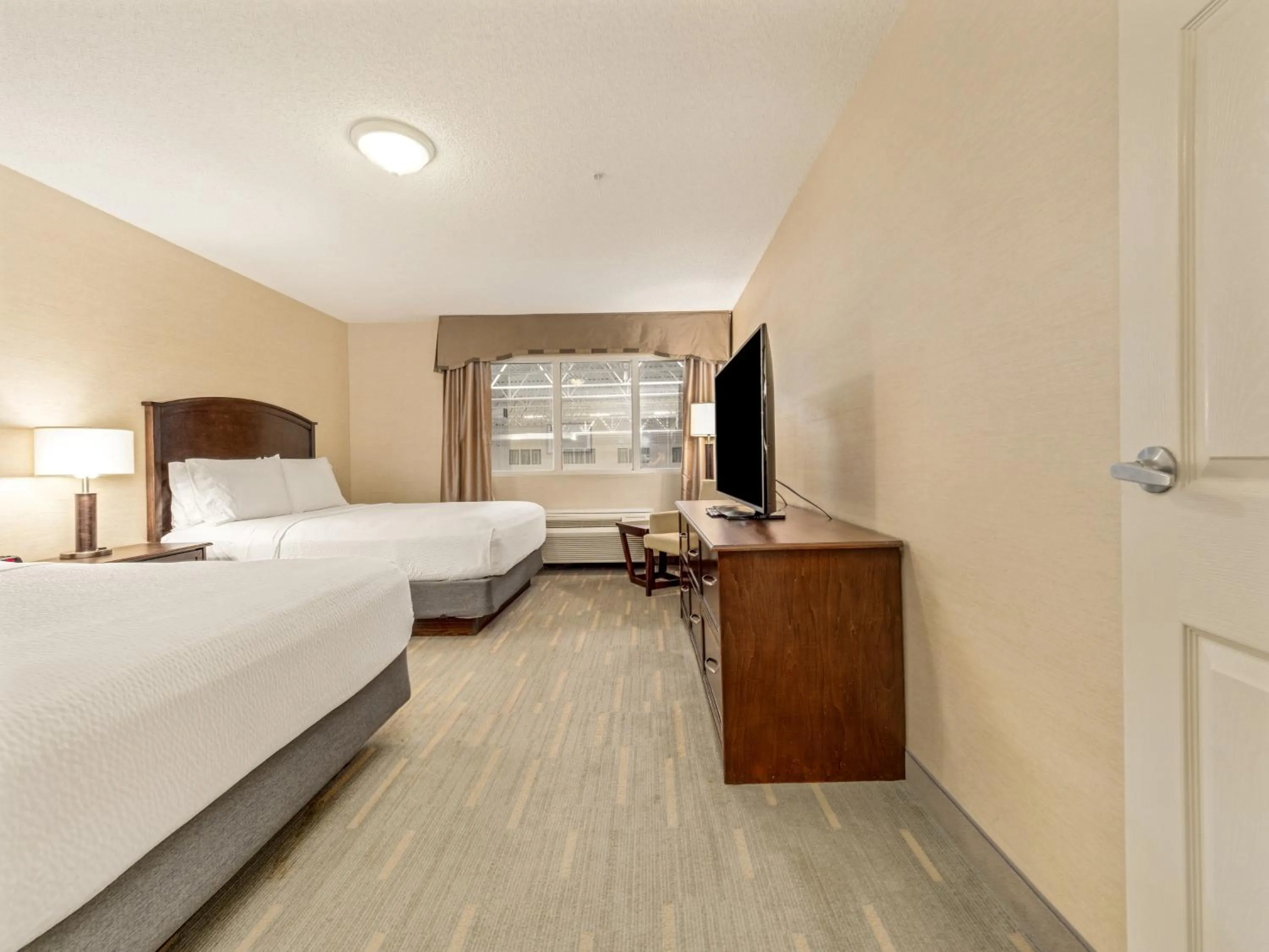 One-Bedroom Suite with Three Queen and One Sofa Bed - Pool View in Holiday Inn Lethbridge by IHG