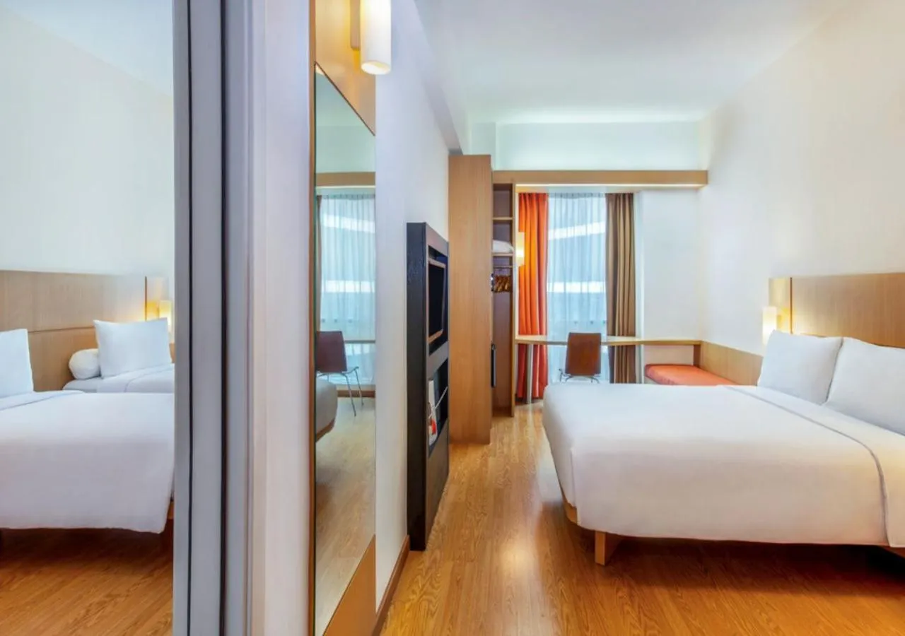Family Room with Queen Bed and Two Single Beds in Ibis Bandung Trans Studio
