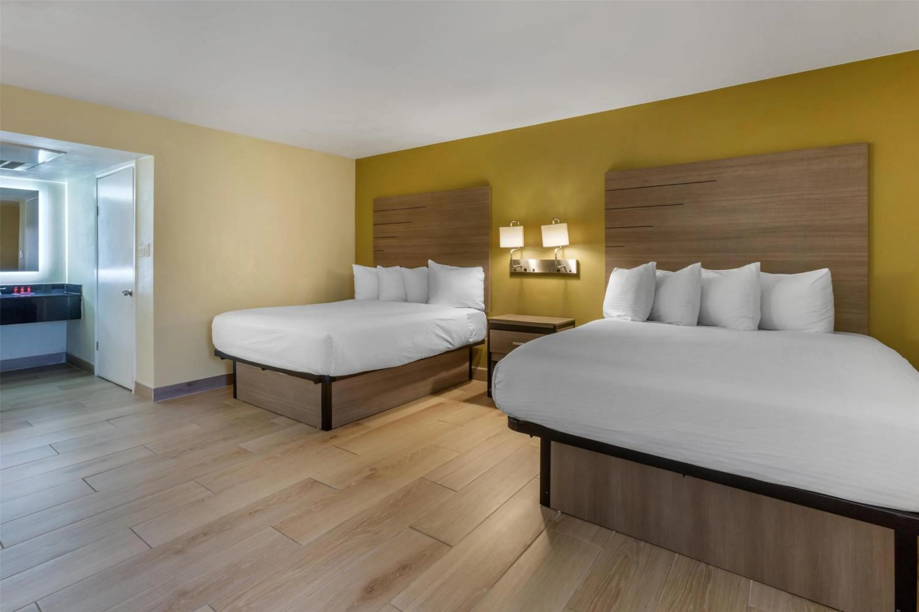 Queen Room with Two Queen Beds and Mobility Accessible Bathtub in SureStay by Best Western Chambers Petrified Forest