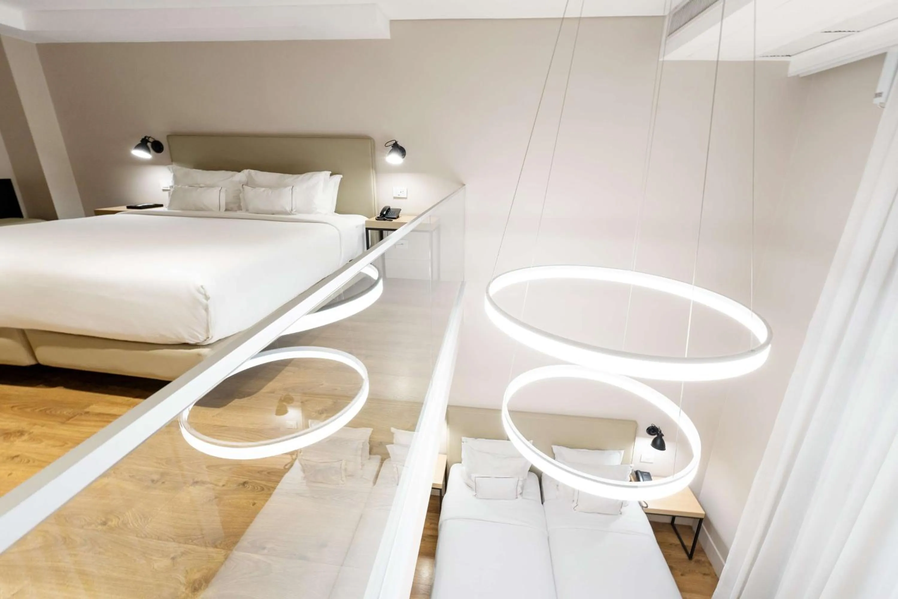 Duplex Family Room with One King Bed and Two Twin Beds in Palmaroga Hotel Asuncion, Tapestry Collection by Hilton