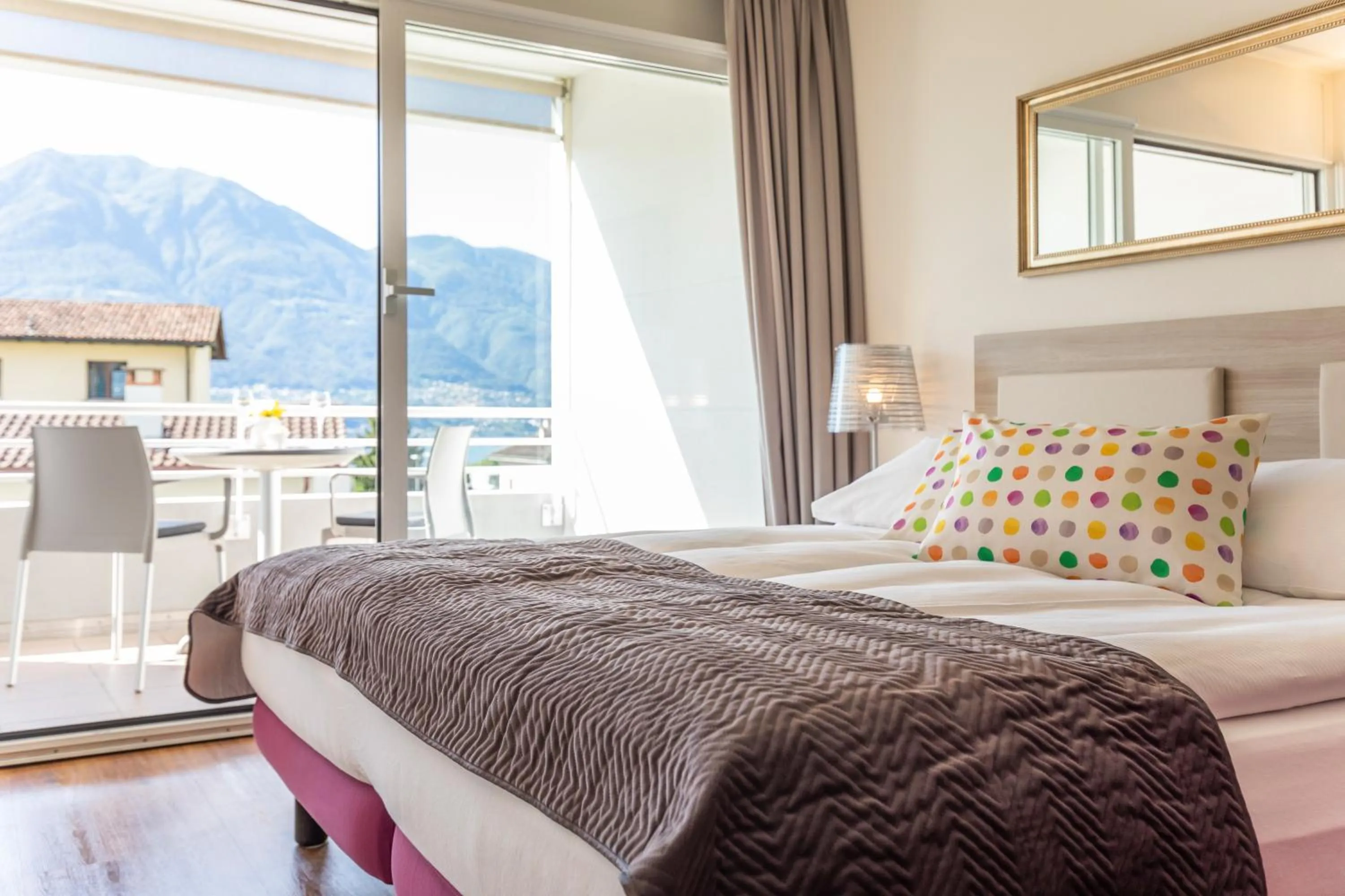 Family Room with Balcony and Partial Lake View in Smart-HOTEL MINUSIO, a Swiss Quality Hotel
