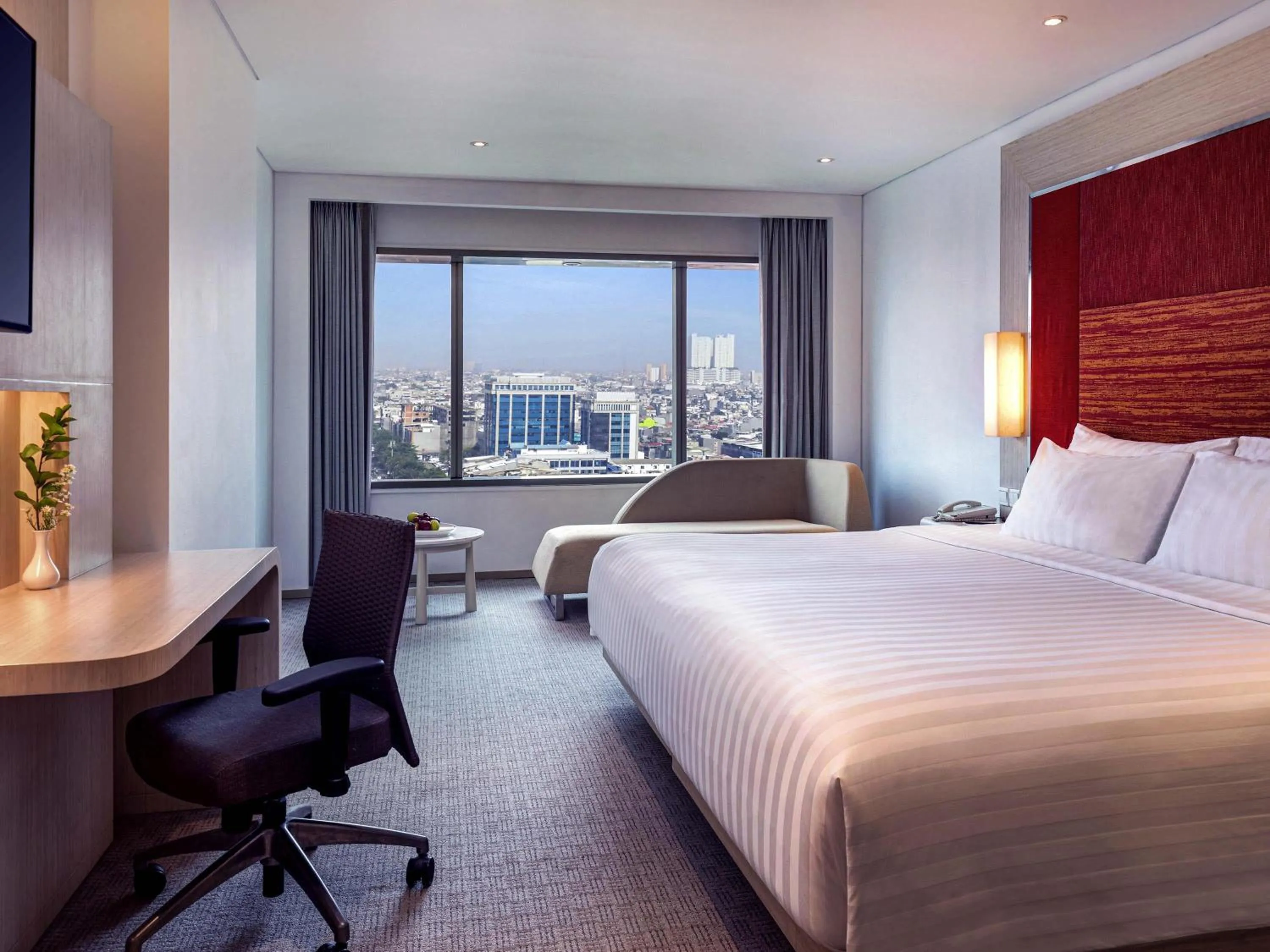 Grand Deluxe Room with Two Single Beds and Sofa in Grand Mercure Jakarta Harmoni