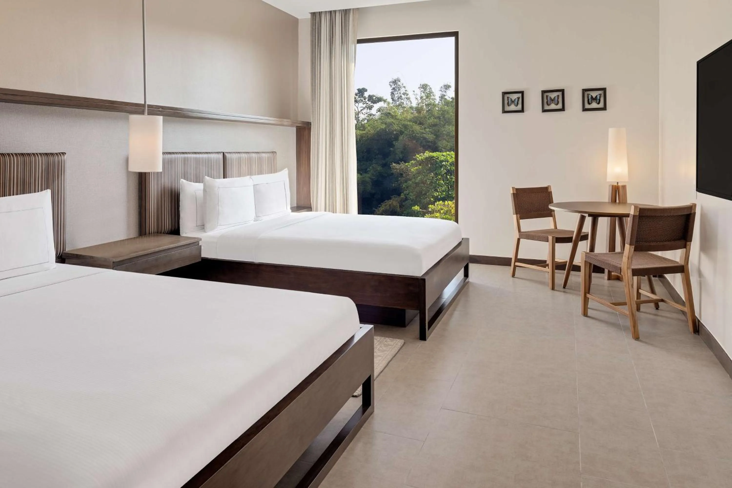 Queen Room with Two Queen Beds and Seating Area in Botanika Osa Peninsula, Curio Collection By Hilton