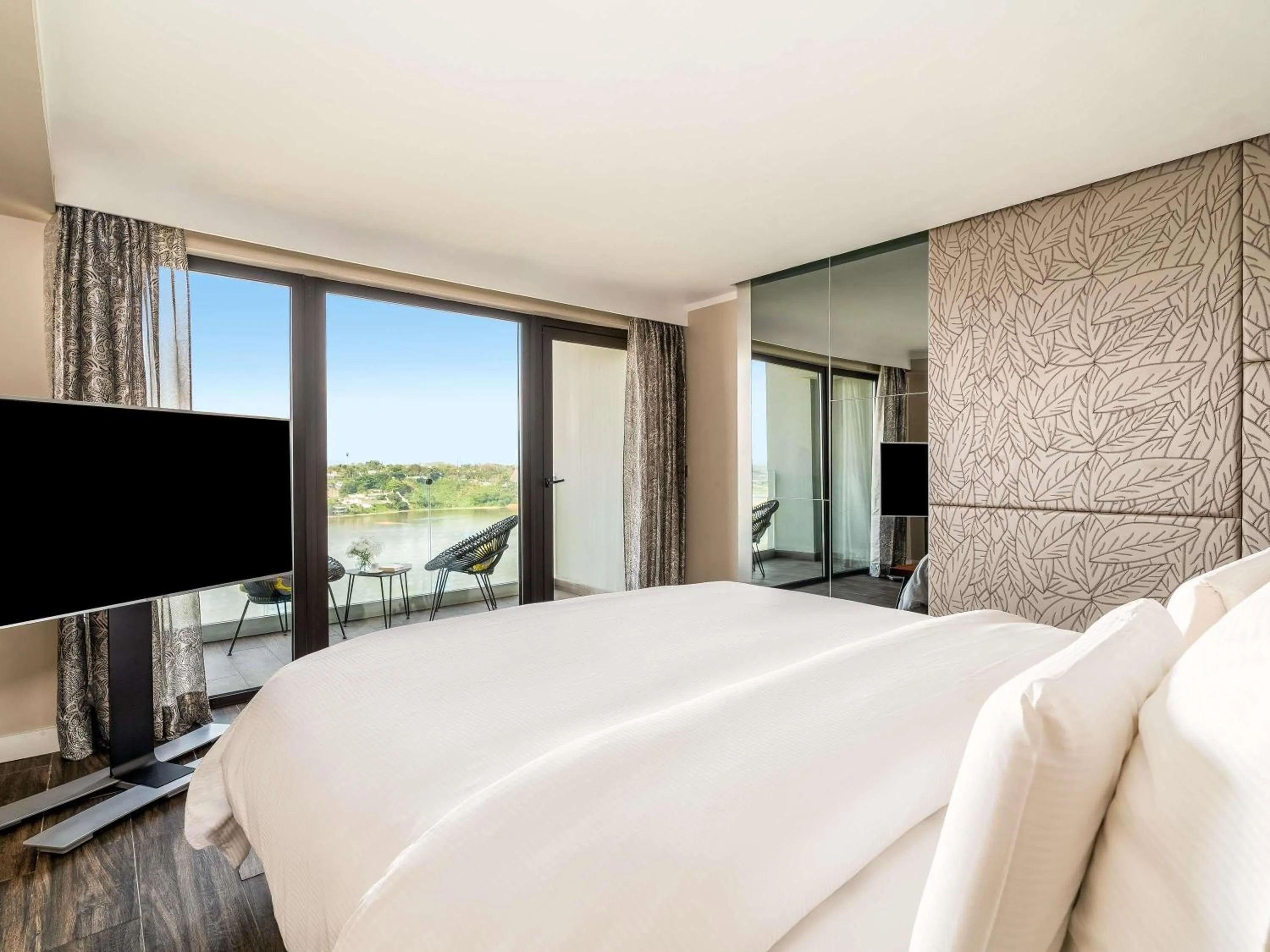 Deluxe Corner King Room with Balcony and Lagoon View in Pullman Abidjan