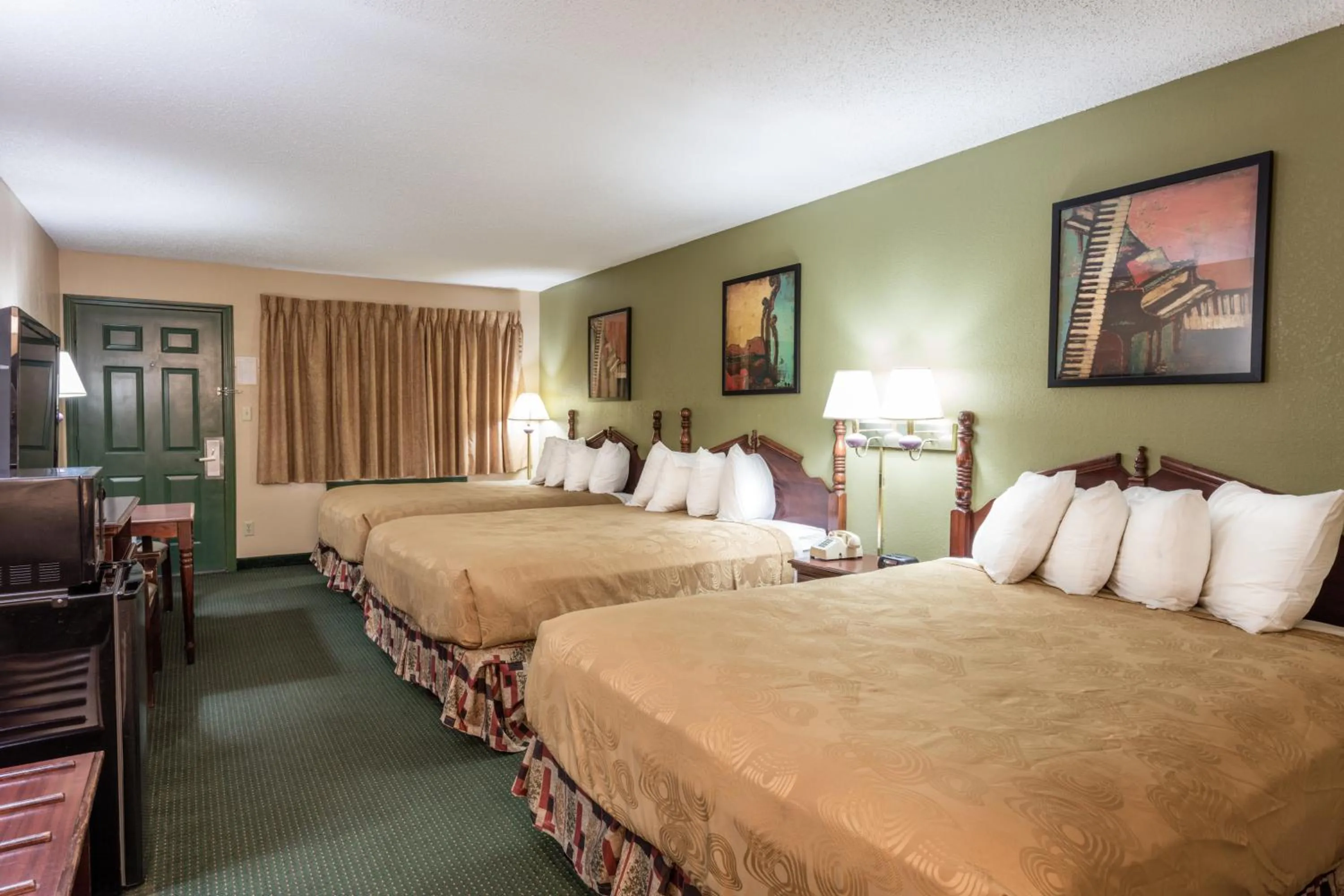 Three Queen Bedroom- Ground Level in Angel Inn Near IMAX, a Travelodge by Wyndham