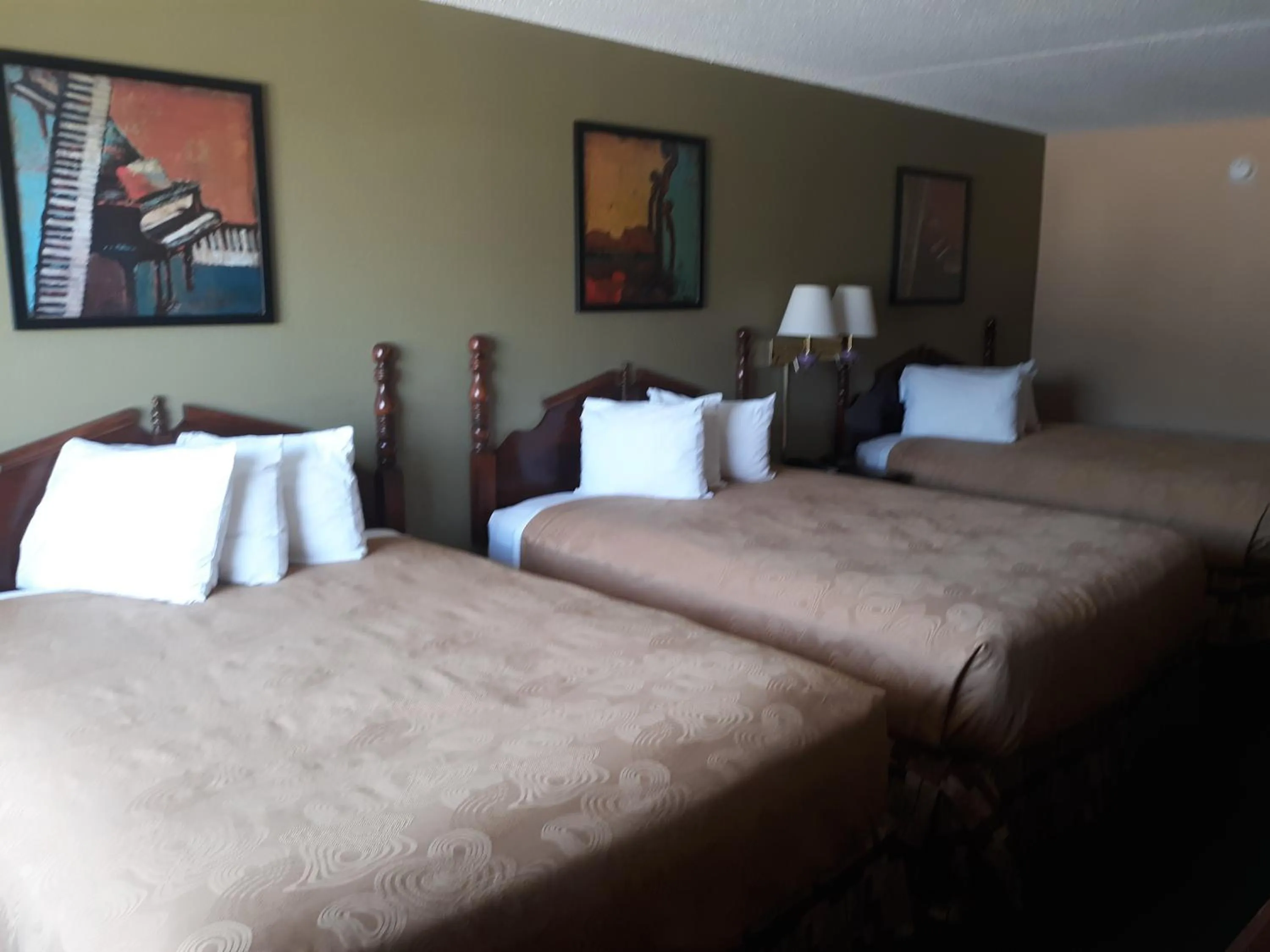 Three Queen Bedroom- Ground Level in Angel Inn Near IMAX, a Travelodge by Wyndham